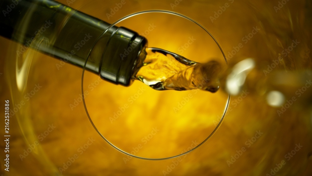 Naklejka premium White Wine Pouring Into Glass From Below