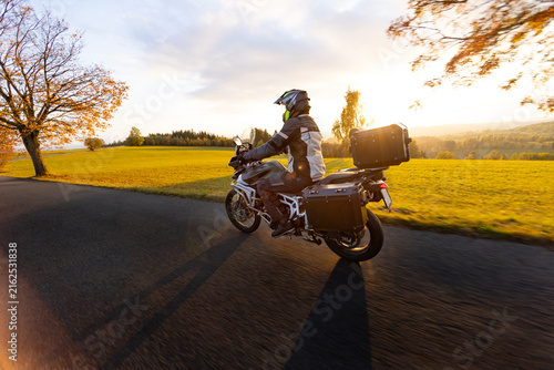 Driver riding motorcycle on empty road