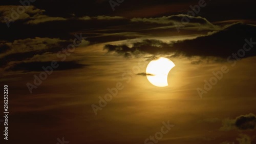 Timelapse of a solar eclipse. The movement of the sun across the sky during sunset and a solar eclipse.
