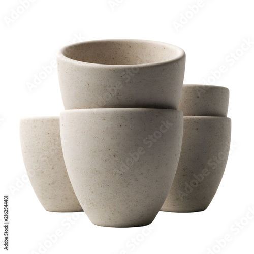 Minimalist ceramic cups in a stacked arrangement. Neutral stone textured pottery set. Modern stoneware vessels for coffee or tea.