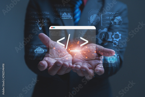 A businessman holds a glowing digital window showing website code brackets in his open hands. Futuristic software development concepts come alive with artificial intelligence and cloud data graphics.
