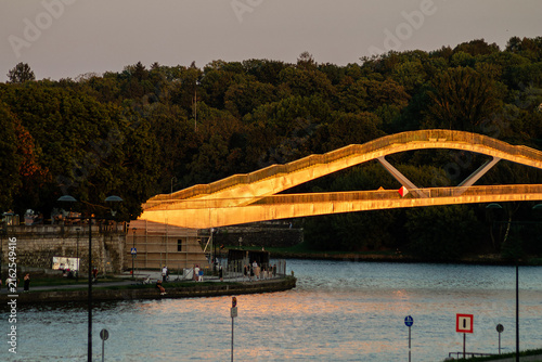 Obraz na plátne Horizontal golden-hour cityscape photo of illuminated bridge over Vistula river