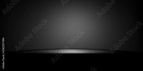 A dark studio background with a central spotlight highlighting a textured surface ideal for minimalist product displays and presentation scenes