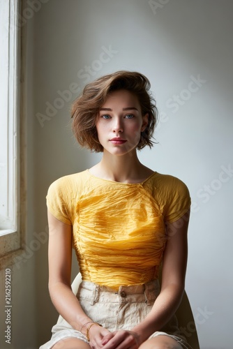 Fashion Model Portrait with Brown Hair and Yellow Background
