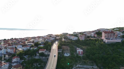Bridge curves uphill.
Highway reaches hillside.
City surrounds viaduct.
Water meets horizon.