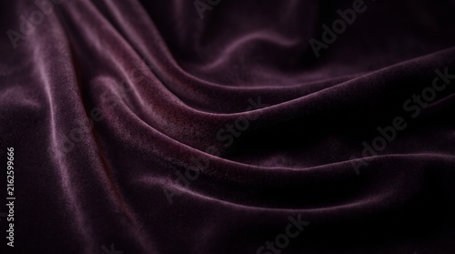 Fotografie Velvet fabric with soft folds displays a luxurious dark purple texture