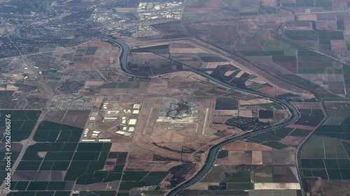 flying along Sacramento International Airport (IATA: SMF, ICAO: KSMF) with Runways, Taxiways, Tarmac, Terminal Buildings and Air Traffic Control Tower, next to river Sacramento River