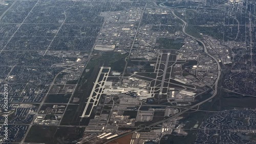 overflying Calgary International Airport (IATA: YYC, ICAO: CYYC) with Runways, Taxiways, Tarmac, Terminal Buildings and Air Traffic Control Tower - 4k aerial video footage