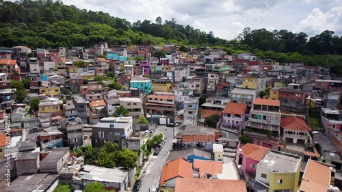 Drone flying low foing towards a humble neighborhood with colorfull houses in São Paulo, Brazil