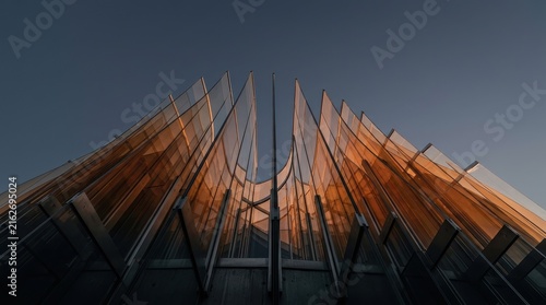 Abstract Curved Glass Fins of Modern Building Facade at Sunset