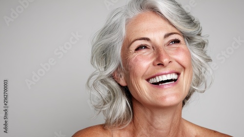 Senior woman smiling portrait, gray hair beauty close-up, joyful mature female face on clean background for wellness ads