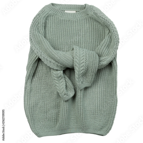 Quadro su tela Sage green chunky knitted sweater with sleeves crossed isolated on white background