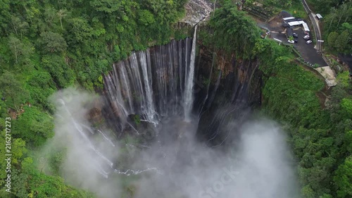 Majestic tumpak sewu waterfall, known as coban sewu, surrounded by lush green tropical rainforest