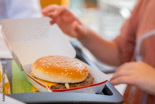 Cuadro en lienzo sesame seed burger held in hands, teenager person holding delicious hamburger, f