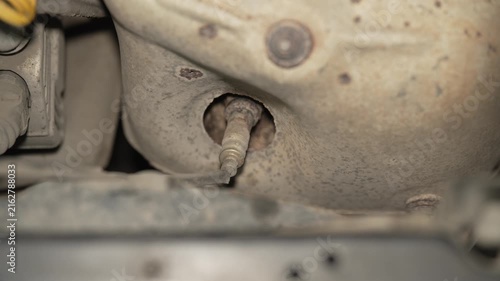 A close up of a car exhaust oxygen sensor lambda probe.