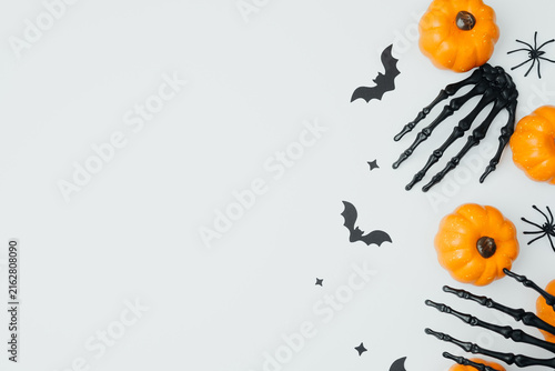 Quadro su tela Orange pumpkins bats spiders skeleton hand festive arrangement on white backgrou