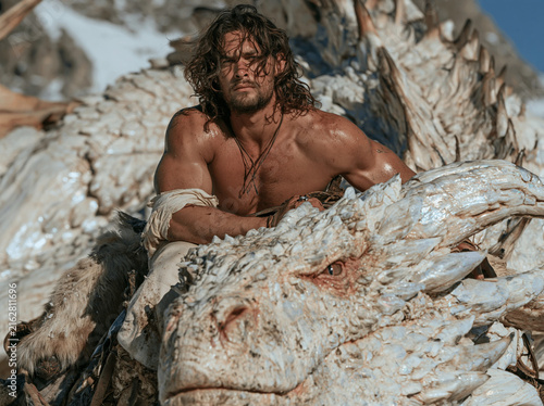 Man Resting on Pale Dragon in Bright Mountain Landscape