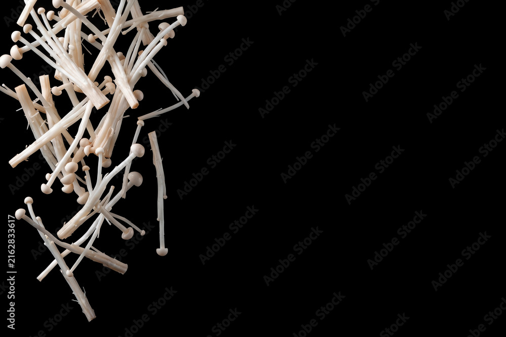 Obraz premium Fresh Enoki Mushrooms Levitating on Black Background with Copy Space