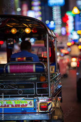 TukTuk vehicle travel in local chinatown Yaowarat at night traffic