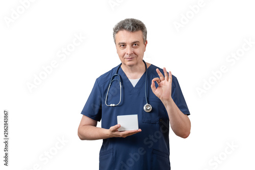 A middle-aged male doctor is holding a medicine box with a space for text.