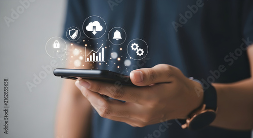 Person holding a smartphone displaying digital business icons for data management, cloud computing, and mobile technology optimization