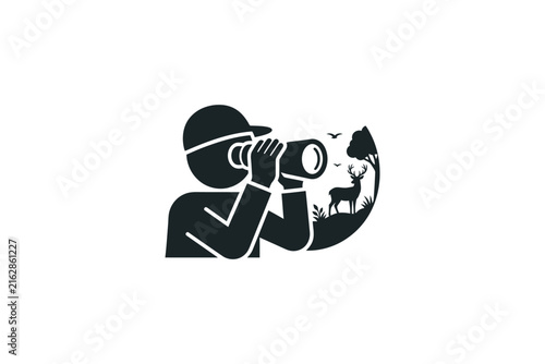 Person with binoculars observing wildlife in nature.