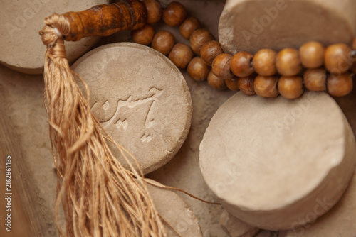 Принти на полотні High-angle, close-up shot of Islamic clay prayer stones (Mohr or Turbah) alongside a wooden rosary (Tasbih)