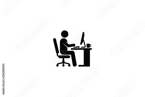Person working at a desk with a computer and coffee cup.