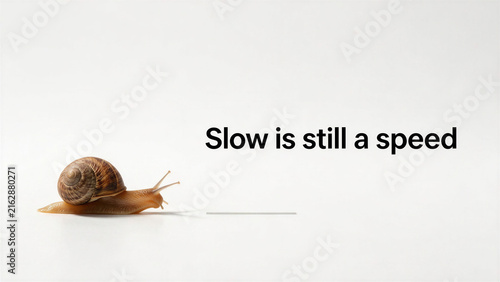 Snail crawling on white surface with text quote 