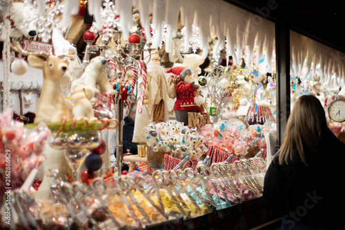 Traditional holiday treats and puppets on sale at a Christmas market stand. Background with no people. 