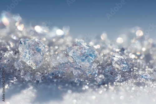 Sparkling Ice Crystals Forming a Shimmering Texture on a Bright White Background for Creative Design and Aesthetic Visuals