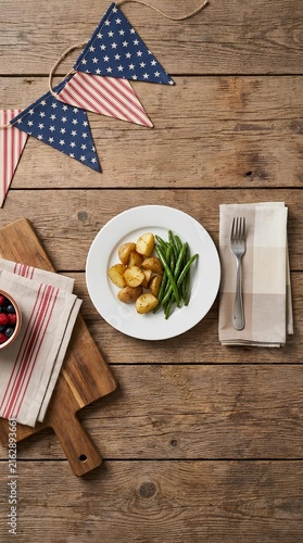 Table setting with food and patriotic bunting decorations.