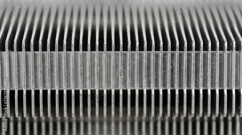 Close up of a metal heatsink with many fins for cooling.