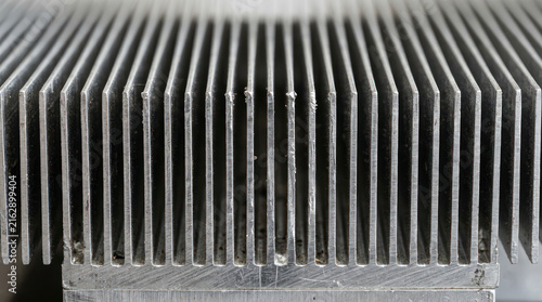Close up of a metal heatsink with many fins for cooling electronics.