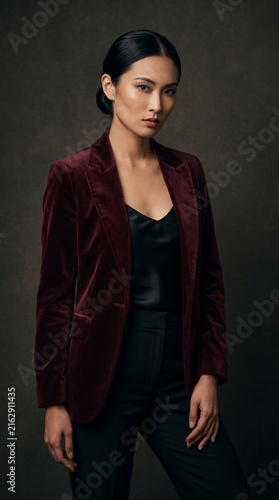 Professional asian businesswoman posing in elegant velvet blazer suit