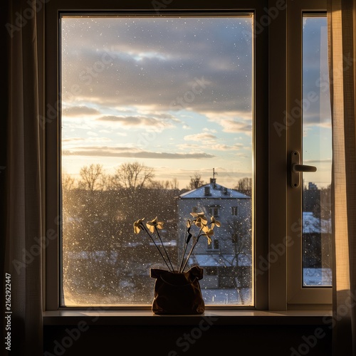 An indoor scene showing intense anticipation of a harsh winter storm contrasted with the sunny reality outside a windowpane ,surprising ,mild ,weather