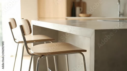 Modern kitchen island with wooden bar stools.