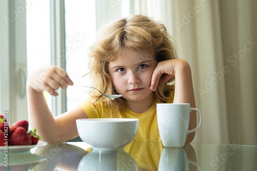 Cuadro en lienzo Bored Child Holding Spoon at Breakfast Table