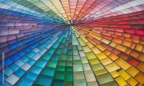 Colorful mosaic tiles radiate outward from a central point
