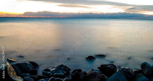 Calm lake with stones in fore ground