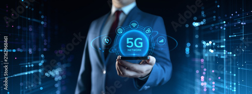 Businessman Holding Smartphone with 5G Network Icons on Screen. Business and Technology concept