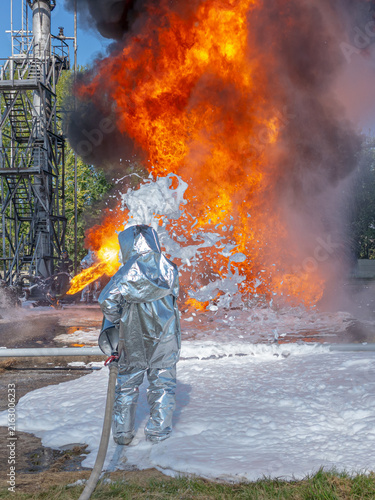 Firefighters use a foam generator to supply foam to extinguish the fire. A fire at the plant caused by the ignition of an oil product. Firefighters extinguish a fire at an oil refinery.