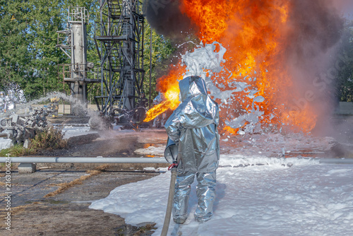 Firefighters use a foam generator to supply foam to extinguish the fire. A fire at the plant caused by the ignition of an oil product. Firefighters extinguish a fire at an oil refinery.
