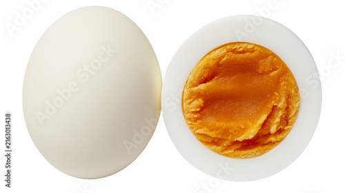 Canvas Print Whole hard-boiled egg next to a halved egg showing yolk and white