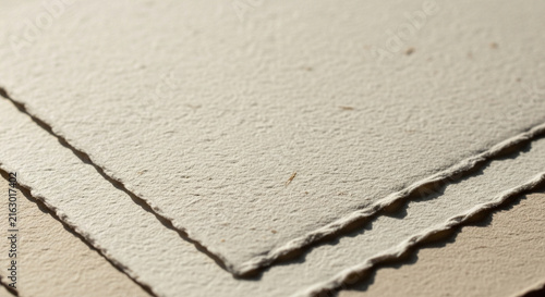 Textured beige paper sheets stacked neatly together
