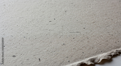 Textured light beige paper surface close up view