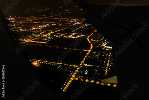 Night view Airplane Window of Shanghai, China Aerial Cityscape Above the Clouds