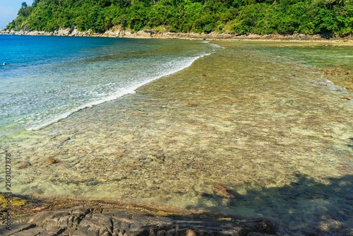 A pristine tropical coastline with turquoise sea palms and a relaxing beach atmosphere – Merlin Beach, uncrowded diving, Patong, Phuket, Thailand.