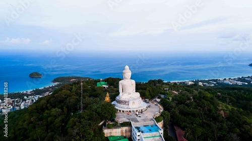 Aerial view blue sky and blue ocean are on the back of Phuket Big Buddha statue. white Phuket big Buddha is the one of landmarks on Phuket island.  No people around at 7 AM.