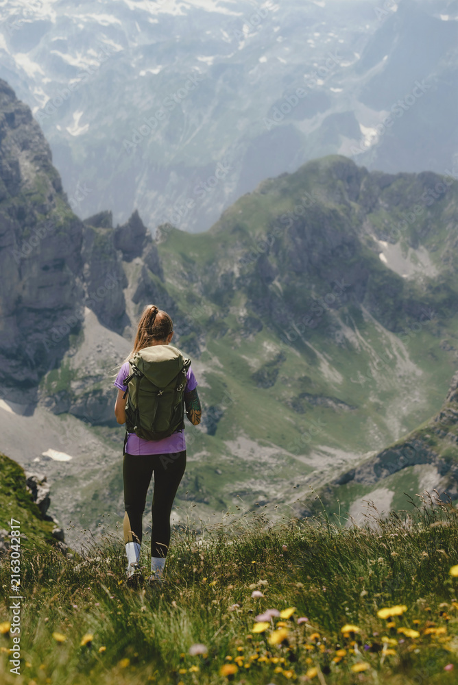 Obraz premium Woman Backpacker Hiking on Rocky Mountain Trail
